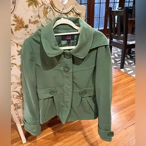 Green fall jacket with detachable hood.